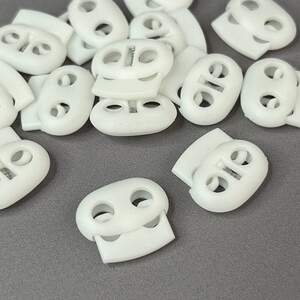 Фиксатор для шнура пластиковый 23 мм, белый